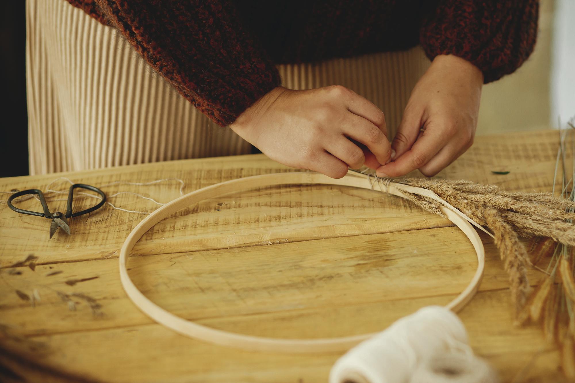 studio hands at work with hoop and needle